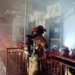 Petugas Damkar saat memadamkan api yang menghanguskan rumah 3 lantai di Kedung Rukem IV No. 53, Kelurahan Kedungdoro, Kecamatan Tegalsari, Surabaya.