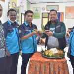 Bupati Fandi Akhmad Yani menyerahkan potongan tumpeng saat menghadiri pelantikan Karang Taruna di Kecamatan Menganti. Foto: SYUHUD/ BANGSAONLINE