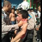 Tersangka Jakfar (28), ketika diamankan polisi saat dihajar massa. foto: istimewa