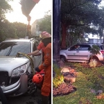 Petugas Damkar Surabaya saat berupaya mengevakuasi mobil anggota Polri yang masuk ke taman di Jalan Raya Menur.