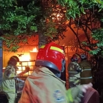 Petugas pemadam kebakaran saat proses pemadaman api di sebuah rumah di Jalan Simo Gunung I No 44, Kecamatan Sawahan, Surabaya. Foto: Ist.