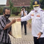 Wali Kota Madiun, Maidi, saat membagikan paket sembako dari rekanan dinas perhubungan kepada sopir angkot dan warga 