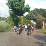 Warga dengan kendaraannya menerjang banjir. foto: istimewa