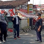 Seremonial pembukaan area yang berisi 30 rumah di Kelurahan Kemasan, ditandai dengan penurunan banner bertuliskan lockdown. (foto: ist)