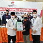 Pasangan QA menyerahkan berkas pendaftaran kepada Ketua KPU Gresik, Achmad Roni. (foto: SYUHUD/ BANGSAONLINE)