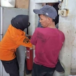 Evakuasi seorang teknisi yang tewas terjepit lift di Surabaya.