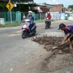 Warga melakukan pengurukan dengan tanah, antisipasi terjadi kecelakaan susulan. (Agus HP/BangsaOnline.com)
