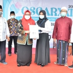 Wabup Bu Min menyerahkan beasiswa kepada mahasiswa berprestasi. foto: SYUHUD/ BANGSAONLINE