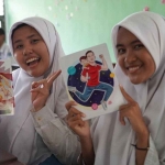 Siswi SMAN 10 Surabaya saat menunjukkan buku bergambar Wakil Presiden RI, Gibran Rakabuming Raka. Foto: Kompas.com