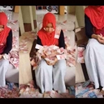 Nila Rahmaniar menunduk saat dilempari uang oleh Ovie. Gambar yang berasal dari video ini kini viral di media sosial. 