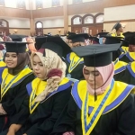 Para wisudawan sedang mengikuti prosesi wisuda.