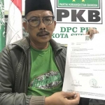 Musyafak Rouf, Ketua DPC PKB Kota Surabaya menunjukkan surat intruksi untuk para kader agar menyosialisasikan Fandi Utomo sebagi Cawali Surabaya. foto: ist