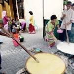 Warga saat mengaduk bubur Syuro di depan masjid Astana Sunan Bonang Tuban. foto: SUWANDI/ BANGSAONLINE