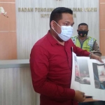 Novli Bernado Thyssen, S.H., Ketua KIPP Jatim saat menunjukkan bukti berupa foto terkait dugaan pelanggaran yang dilakukan oleh Wali Kota Tri Rismaharini saat melapor ke Kantor Bawaslu Surabaya, Kamis (1/10).
