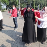 Bupati Gus Yani bersama Wabup Bu Min saat memakaikan jaket kepada relawan pemulasaran jenazah. foto: SYUHUD/ BANGSAONLINE