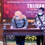 Gubernur Jawa Timur Khofifah Indar Parawansa  saat menandatangani nota kesepakatan tentang kerja sama bidang pertanahan di Gedung Grahadi Surabaya, Jumat (25/9/2020). foto: mma/ bangsaonline.com 