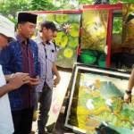 Rasiyo berbincang dengan M Anis seniman lukis yang didatanginya di Bantaran Sungai Ketabang Kali. 