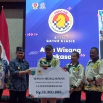 Pj Wali Kota Batu, Aries Agung Paewai, saat menyerahkan bonus kepada salah satu atlet peraih medali di Porprov Jatim 2023.