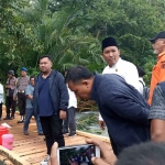 Bupati Gresik, Fandi Akhmad Yani, bersama Ketua DPRD Gresik, Much Abdul Qodir, saat mencoba jembatan darurat yang terbuat dari kayu di Desa Kelompang Gubuk, Kecamatan Tambak. Foto: Ist