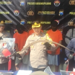 Kapolsek Karang Pilang A. Risky Fardian bersama Kasi Humas Polrestabes Surabaya saat menunjukan keempat pelaku pembacokan dan barang bukti berupa sajam.