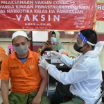 Vaksinasi warga binaan pemasyarakatan di Lapas Narkotika Kelas IIA Pamekasan dilaksanakan di ruang kunjungan, Sabtu (10/07/2021). foto: Ferdiana Lestari/ BANGSAONLINE.com