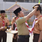 SIMBOLIS: Kalapas melakukan penyematan baret anggota Pramuka pada warga binaan, Jumat (12/10). foto: ist