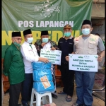 Yusub Hidayat, Ketua LAZISNU Kota Surabaya menyampaikan langsung bantuan untuk korban gempa Malang di Pos Lapangan NU Peduli kepada Ketua PCNU Kabupaten Malang, dr. Umar Usman. foto: istimewa.