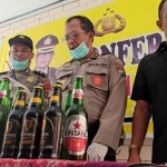 Petugas memamerkan barang bukti sejumlah botol miras yang berhasil diamankan saat operasi pekat.