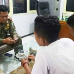 Dandung Djulharjanto, Kabid Trantib Satpol PP Kota Malang, saat memeriksa Hp milik salah satu siswa yang kedapatan menyimpan foto tidur berdua dengan pacarnya.