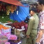 Satpol PP saat memperingatkan pedagang di pasar buah untuk merapikan dagangannya. (Ferry/BangsaOnline)