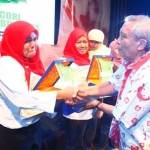 Ibu Aminah menahan tangis bahagianya ketika menerima penghargaan.