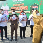 Wabup Bu Min saat menempel stiker Gresik Jaman Now di mobil dinasnya. (foto: SYUHUD/ BANGSAONLINE)