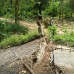 Jembatan penghubung Desa Montongsekar dan Tanggulangin yang putus. Tampak pengendara motor terpaksa menerjang sungai karena enggan memutar jauh.