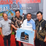 Kepala Departemen Distribusi dan Transportasi Semen Indonesia, Wahyu Purnomo (tiga dari kiri) menyerahkan hadiah ibadah umrah kepada Suharno. foto: ist