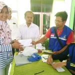 Kabid Pemberdayaan Sosial Dinsos-P3A Kabupaten Tuban Harsono Tri Asworo menyerahkan bantuan pada pengungsi.