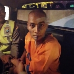 Tersangka Arif Hariyanto diamankan polisi memakai baju tahanan. 