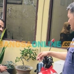 Kasi Humas Polsek Pesantren, Aipda Prisma Nugroho (kanan) dan Suparlan, pemilik sepeda motor. Foto: MUJI HARJITA/BANGSAONLINE