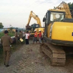 Petugas Dispol PP Gresik menghentikan proyek pemasangan pipa Pertamina Gas di Desa Kedanyang Kebomas. foto: SYUHUD/ BANGSAONLINE