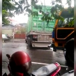 Tampak sejumlah truk trailer langsung menyeberang dari u-turn untuk masuk ke gudang semen di Jalan Raya Sukomanunggal.