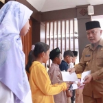 Bupati Malang, Sanusi, saat menyerahkan bantuan untuk anak yatim piatu.