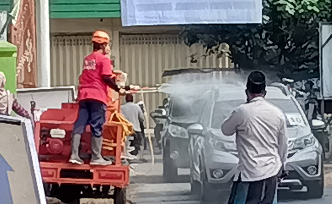 Petugas dan panitia menghentikan setiap mobil pengantar di pintu gerbang Ponpes Lirboyo, untuk disemprot disinfektan. foto: MUJI HARJITA/ BANGSAONLINE