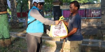 Sambil Gowes, Kapolres Ngawi Bagikan Bansos kepada Petugas Kebersihan