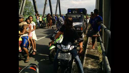 Upaya pencarian korban yang menarik perhatian warga di jembatan tempat korban terjun ke sungai.