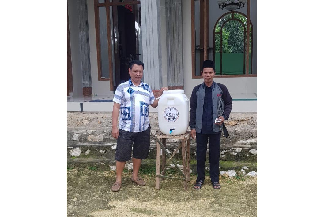 Ketua Forsim H. Chosen (kanan) usai menyerahkan wastafel ke Kamiluddin, Sekretaris Masjid Baiturrahman Desa Sumur Kuning, Kecamatan Kwanyar.