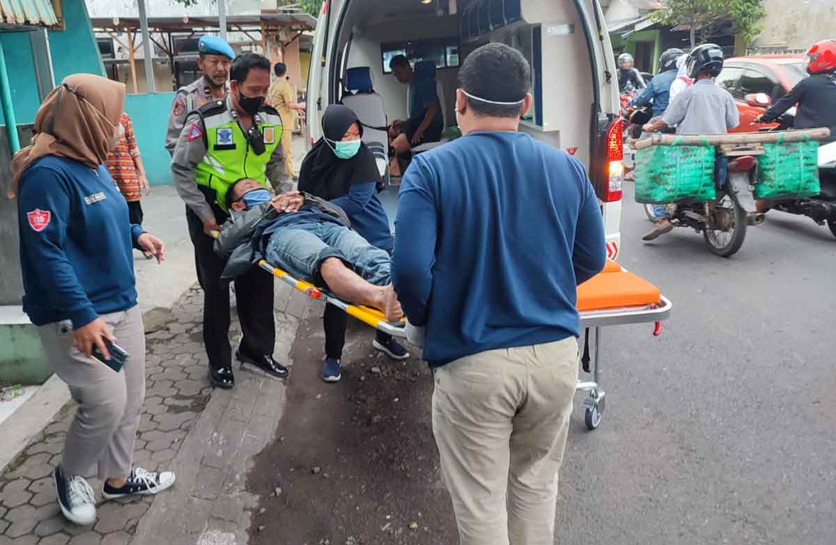 Petugas dari Polsek Prajurit Kulon saat mengevakuasi korban kecelakaan di Jalan Tribuana Tungga Dewi, Kota Mojoketo.