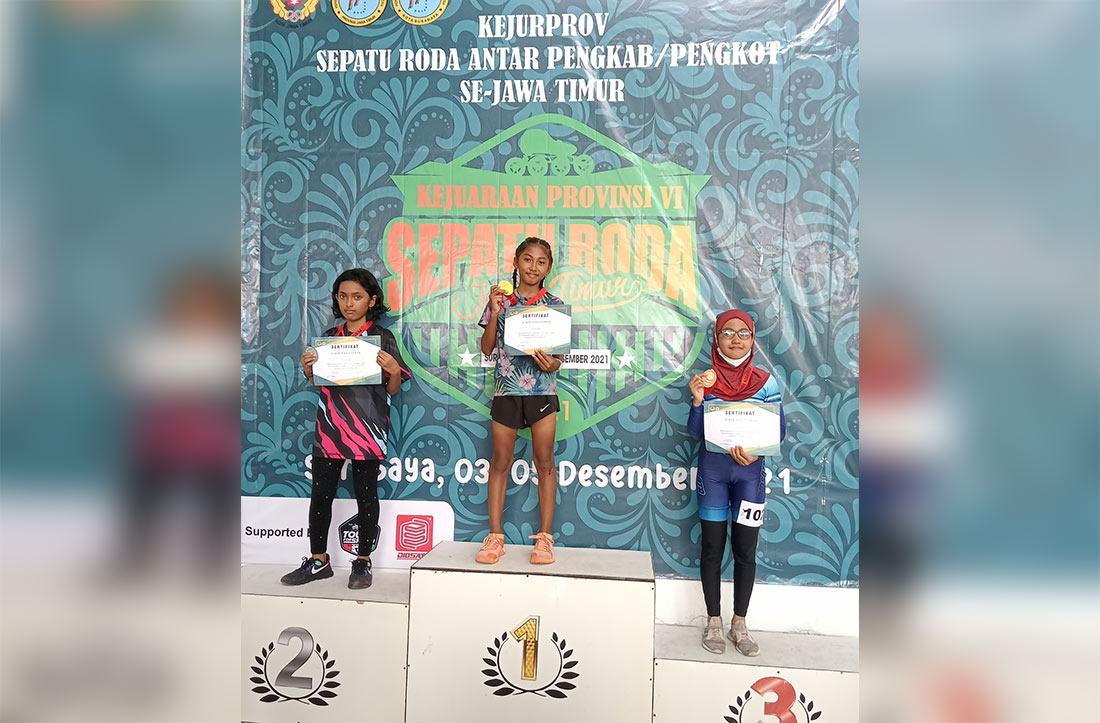 Atlet sepatu roda andalan Kabupaten Gresik May Annaya Syahputri (Memey/tengah) naik podium menerima emas Kejurprov 2021 di arena GBT. foto: ist.