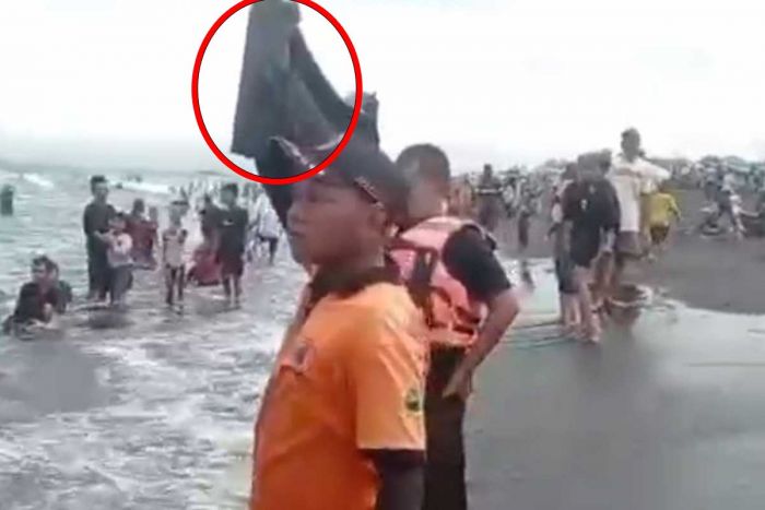 Relawan Peringatkan Wisatawan yang Mandi di Pantai Paseban Jember dengan Kantong Jenazah Relawan Peringatkan Wisatawan yang Mandi di Pantai Paseban Jember dengan Kantong Jenazah