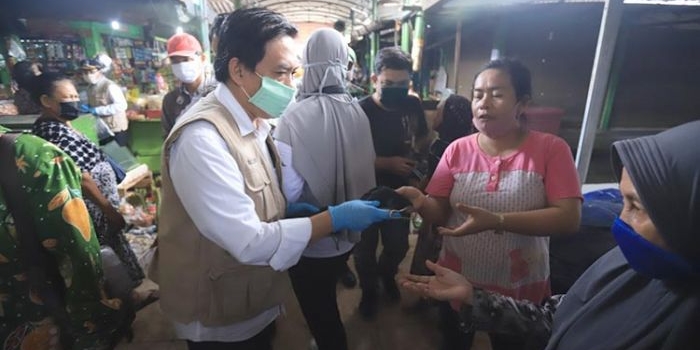 AYO DIPAKAI: Wabup Nur Ahmad Syaifuddin memberikan masker kepada warga di Pasar Taman yang kedapatan tak menggunakan masker, Jumat (17/4). foto: ist