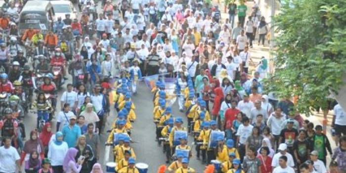 START - Para peserta mulai keluar dari parkir timur Surabaya Plaza dengan didahului oleh marching band. foto: Satria/BANGSAONLINE