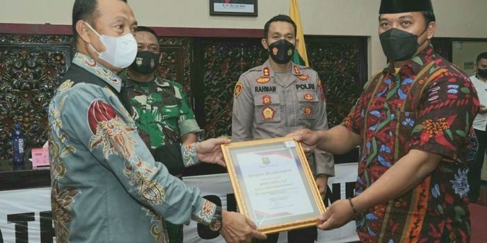 Bupati Sumenep, Achmad Fauzi, saat memberi penghargaan kepada kecamatan dan desa/kelurahan yang telah melakukan percepatan vaksinasi Covid-19 terbaik.